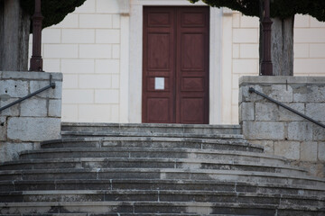 Poster - Low angle shot of a wide staircase to a white stone building with entrance door in the center