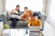 © Kris Tan - Asian Parents and a kid child look at a laptop at home. Family concept.