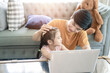 © Kris Tan - Father and daughter playing with Notebook computer at home