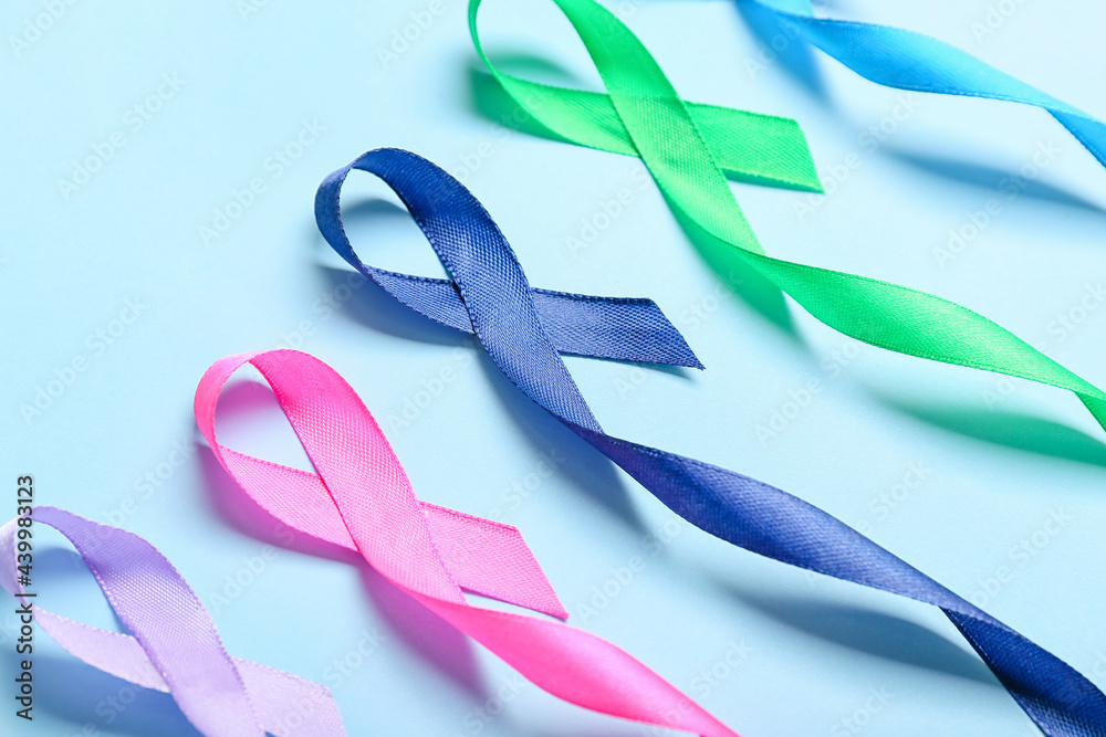 Different awareness ribbons on color background, closeup