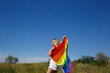 © Aleksandra Iarosh - girl with lgbt flag behind her back against a bright blue sky