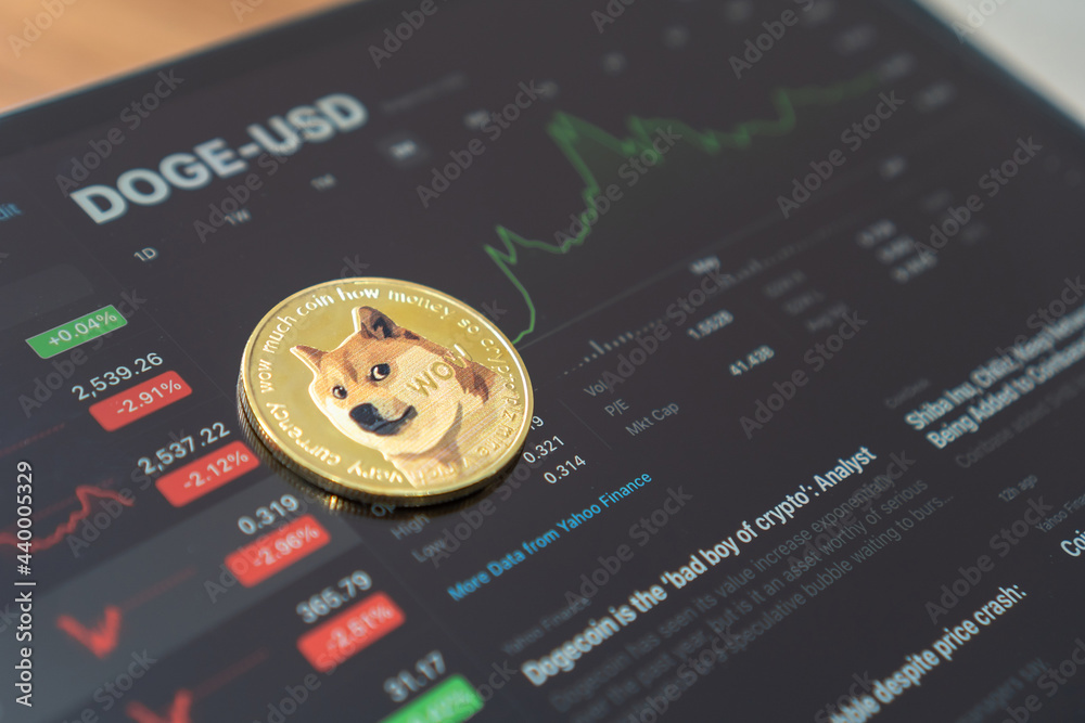 Bangkok, Thailand - June 16, 2021: Dogecoin Doge coin cryptocurrency, digital crypto currency tokens for defi decentralized financial banking p2p global investment financial business stock market