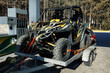 ATV loaded on a trailer for transportation near gas station