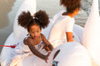 © winnievinzence - African American girl playing on goose rubber ring at the beach with sister. travel vacation on holiday