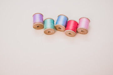 Sticker - Colorful sewing threads on a light background with free space for text