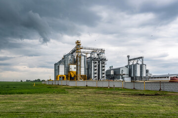 Wall Mural - Modern Granary elevator and seed cleaning line. Silver silos on agro-processing and manufacturing plant for processing drying cleaning and storage of agricultural products, flour, cereals and grain.