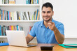 © Daniel Ernst - Hispanic hipster man with beard at computer recommending stay at home