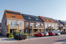 Newly Build Houses With Solar Panels Attached On The Roof Against A Sunny Sky Close Up Of New Building With Black Solar Panels. Zonnepanelen, Zonne Energie, Translation: Solar Panel, , Sun Energy