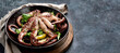 © bit24 - Grilled octopus served with spices and lemon on gray background. Seafood concept.