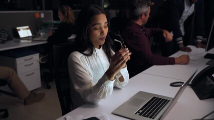 Mixed race business woman working late at night in office rubbing tired eyes finishing off assignments 