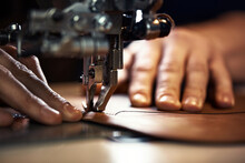 A Sewing Machine Foot With The Hands Of A Master Close-up, A Tailor Makes A Seam On A Piece Of Leather On A Sewing Machine, The Concept Of Sewing Leather Products