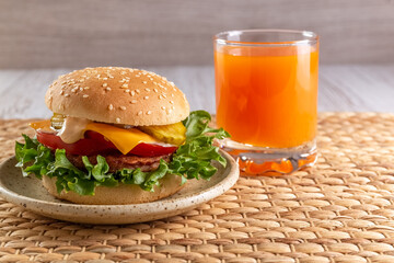 Delicious and healthy burger and fruit juice for breakfast and lunch. Homemade recipe. Fast food. Concept. High quality photo