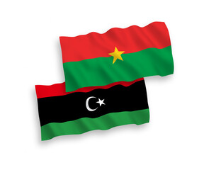 National vector fabric wave flags of Burkina Faso and Libya isolated on white background. 1 to 2 proportion.