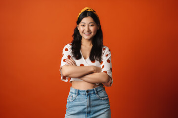 Wall Mural - Smiling young asian woman in summer clothes standing