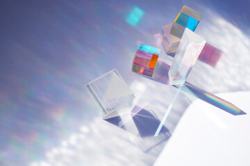 Abstract background with glass geometric figures prisms with light diffraction of spectrum colors and complex reflection.