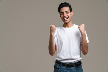 Smiling young brunette man in t-shirt standing