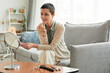 © Seventyfour - Portrait of elegant mature woman doing makeup and looking in mirror in cozy home setting, copy space