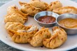 Plate of traditional momos served with tasty dipping.
