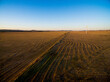 © Austockphoto - Drone shot of wind turbines in stubble paddock in late afternoon
