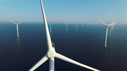 offshore windmill park with clouds and a blue sky, windmill park in the ocean aerial view with wind 
