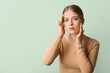 © Pixel-Shot - Teenage girl with acne problem on color background