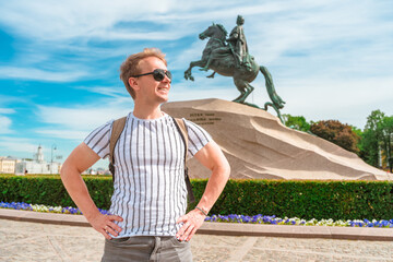 Man tourist walks through the summer St. Petersburg near the monument of the Bronze Horseman