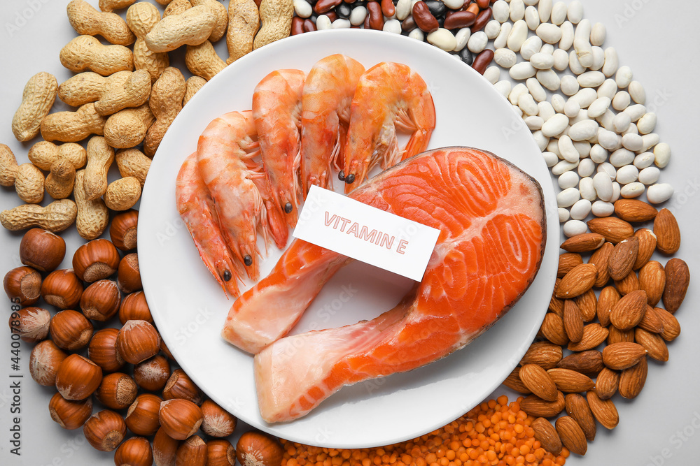 Plate with healthy products rich in vitamin E on white background, closeup