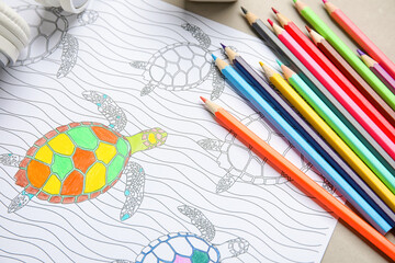 Wall Mural - Coloring picture and pencils on table, closeup