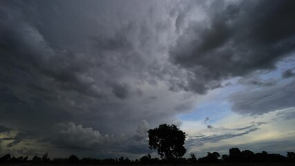 Wall Mural - the sky and rain clouds move quickly over the fields in the evening.
