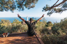 The Tourist Raised His Hands Up, Reaching The Path To The Lighthouse. View Of The Lighthouse Helidonia From The Lycian Trail. Panoramas Of The Mediterranean Sea.