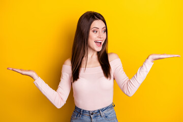 photo of young happy excited crazy girl look palm hold hands in balance advertisement isolated on ye