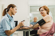 © milanmarkovic78 - Nurse Checking The Blood Pressure Of Senior Woman
