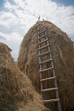 Capture Of A Haystack With A Wooden Ladder On It During Summer. Rural Scene In The Rhodopes, Bulgaria