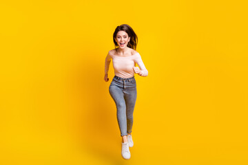 Sticker - Full size photo of young happy excited beautiful charming girl running fast speed in air isolated on yellow color background