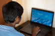 © Shiv Mer - Portrait of a young Indian teen typing on laptop. Indian student uses laptop to complete his assignment. Online education concept. Kid typing on his laptop to complete his school project.