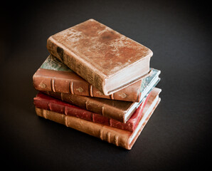 Stack of old books on black background