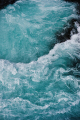 Wall Mural - bruarfoss waterfall in iceland as an abstract of the blue water and whitewater from above