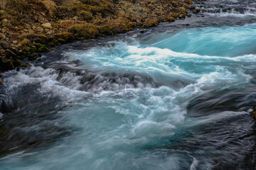 Wall Mural - bruarfoss waterfall in iceland showing it's true blue colors on a cold spring day