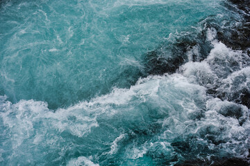 Wall Mural - bruarfoss waterfall in iceland as an abstract of the blue water and whitewater from above