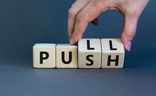 Pull Or Push Symbol. Businessman Turns Wooden Cubes And Changes The Word 'push' To 'pull'. Beautiful Grey Background, Copy Space. Business And Pull Or Push Concept.