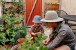 © Ashley Corbin-Teich/Westend61 - Smiling mother with toddler boy holding potato in back yard garden