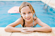 © LIGHTSY STUDIO/Westend61 - Smiling girl at poolside