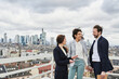 © Annika List/Westend61 - Female entrepreneur explaining to colleagues on rooftop