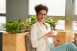 © Annika List/Westend61 - Confident businesswoman with coffee cup sitting at office