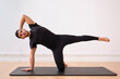 © Antonio Ovejero Diaz/Westend61 - Mid adult man stretching on mat in exercise room