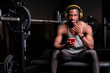 © Antonio Ovejero Diaz/Westend61 - Young man with headphones using smart phone at gym