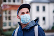 © Angel Santana Garcia/Westend61 - Man with gray eyes looking away while wearing protective face mask during pandemic