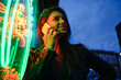 © Angel Santana Garcia/Westend61 - Smiling woman using mobile phone by standing illuminated light