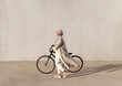 © Picua Estudio/Westend61 - Mature woman walking with bicycle on footpath during sunny day