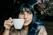© MORNINGVIEW AGENCY/Westend61 - Beautiful woman having coffee while looking away